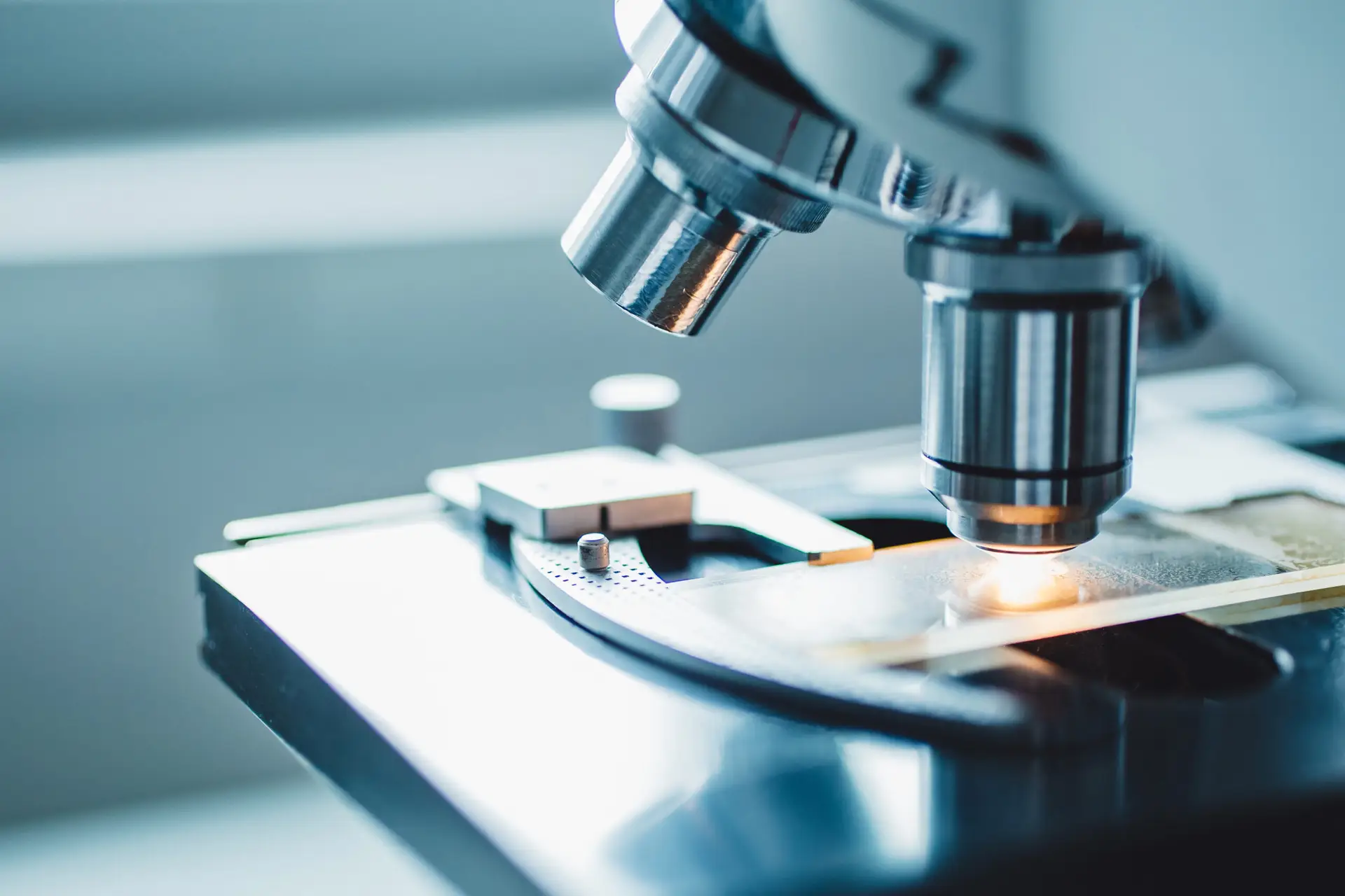 Close-up shot of microscope with metal lens at laboratory.